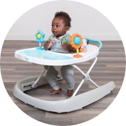 A child is using the Smart Steps walker to learn how to walk